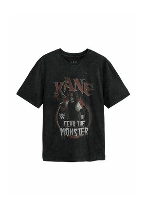 T-shirt noir avec le texte "KANE", logo WWE et une image d’un catcheur avec la phrase "Fear the Monster" sur le devant.