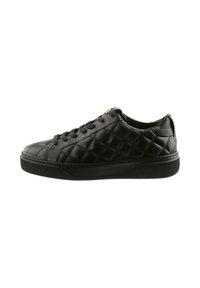Black quilted leather sneaker with round toe, lace-up front, and textured rubber sole. Features subtle gold hardware on the tongue.