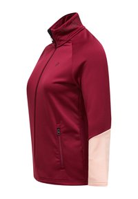 Bordeaux farvet zip-up jakke med høj krave, der har en kontrastfarvet lys pink ærme. Glat stof med sidelomme og logo-detalje på kraven.