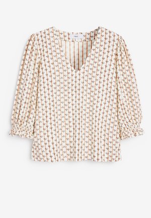 Blouse crème avec des rayures verticales marron et de petits motifs floraux, col en V et manches trois-quarts bouffantes avec poignets élastiques.