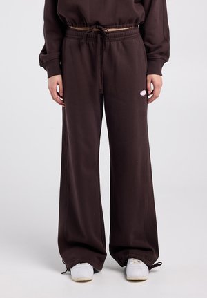 Brown wide-leg sweatpants in soft fabric with an elastic waist and adjustable drawstring; features a small logo on the left thigh.