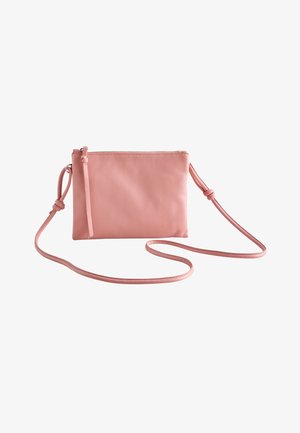 Small pink leather crossbody bag with a slim adjustable strap and zipper closure on a white background.