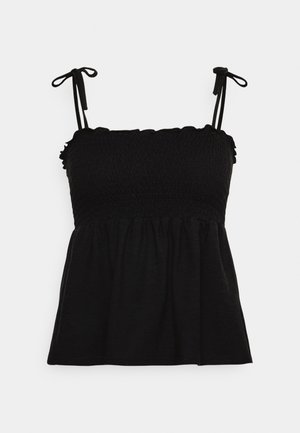 Top negro sin mangas con cuerpo fruncido, escote con volantes y tirantes con lazos sobre un fondo blanco liso.