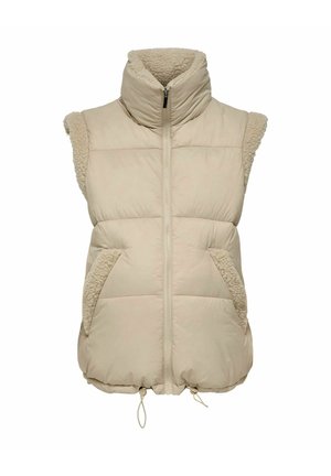 Bēša bezroku pūdera veste ar augstu apkakli, rāvējslēdzēja aizdari un struktūrētām shearling detaļām uz pleciem un kabatām. Auklas aizdare apakšmalā.