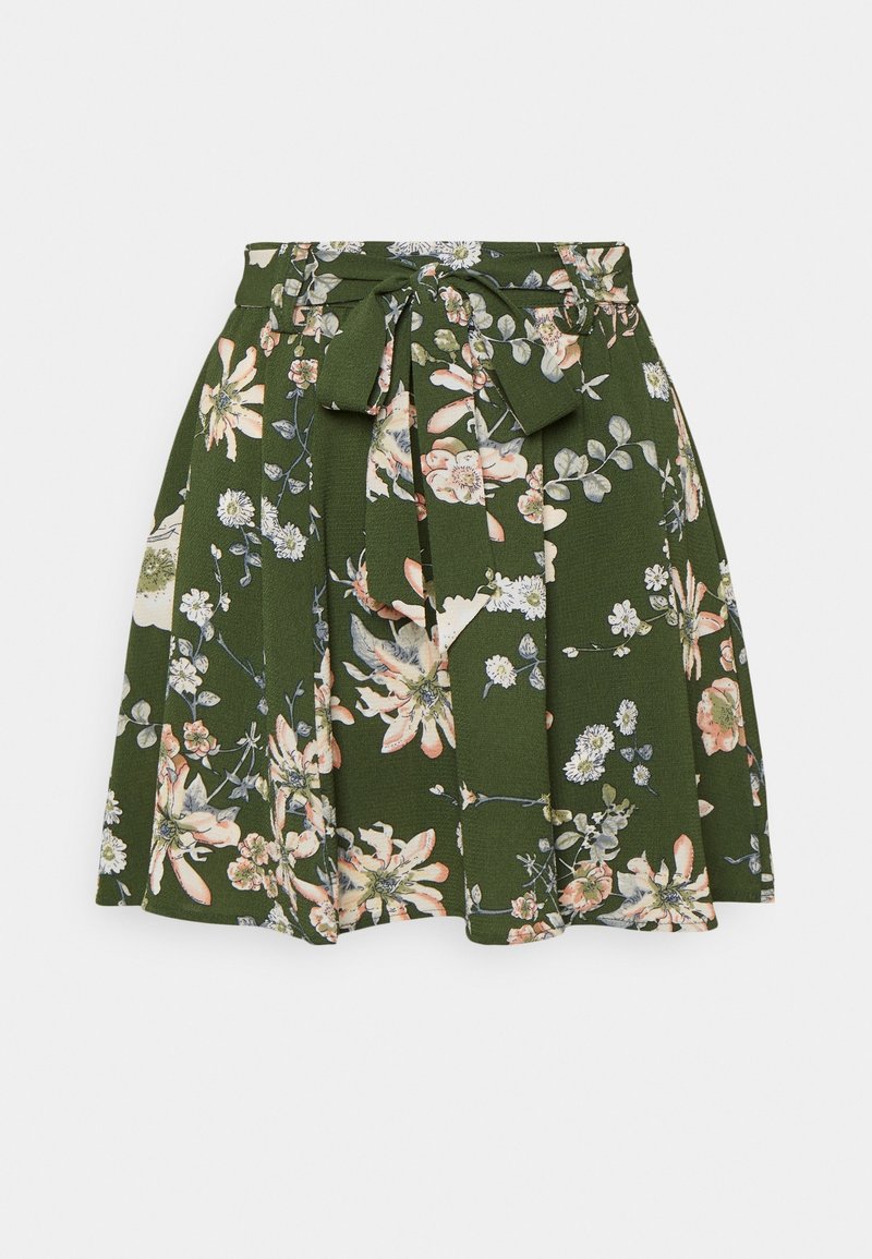 Jupe trapèze verte à motifs floraux avec plis et ceinture en tissu attachée à la taille, ornée de fleurs blanches, roses et beiges.