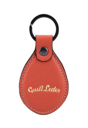 Teardrop-shaped textured orange leather keychain with black metal ring and black button, featuring gold "Gusti Leder" text.