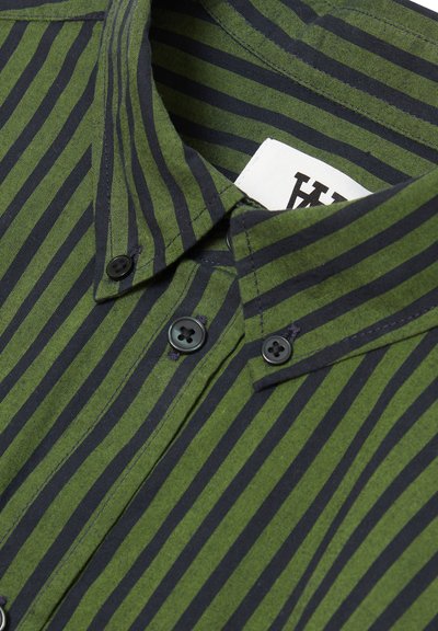 Green and black striped shirt featuring a collared neckline, two buttons, and fabric with a smooth texture. Care label visible inside collar.