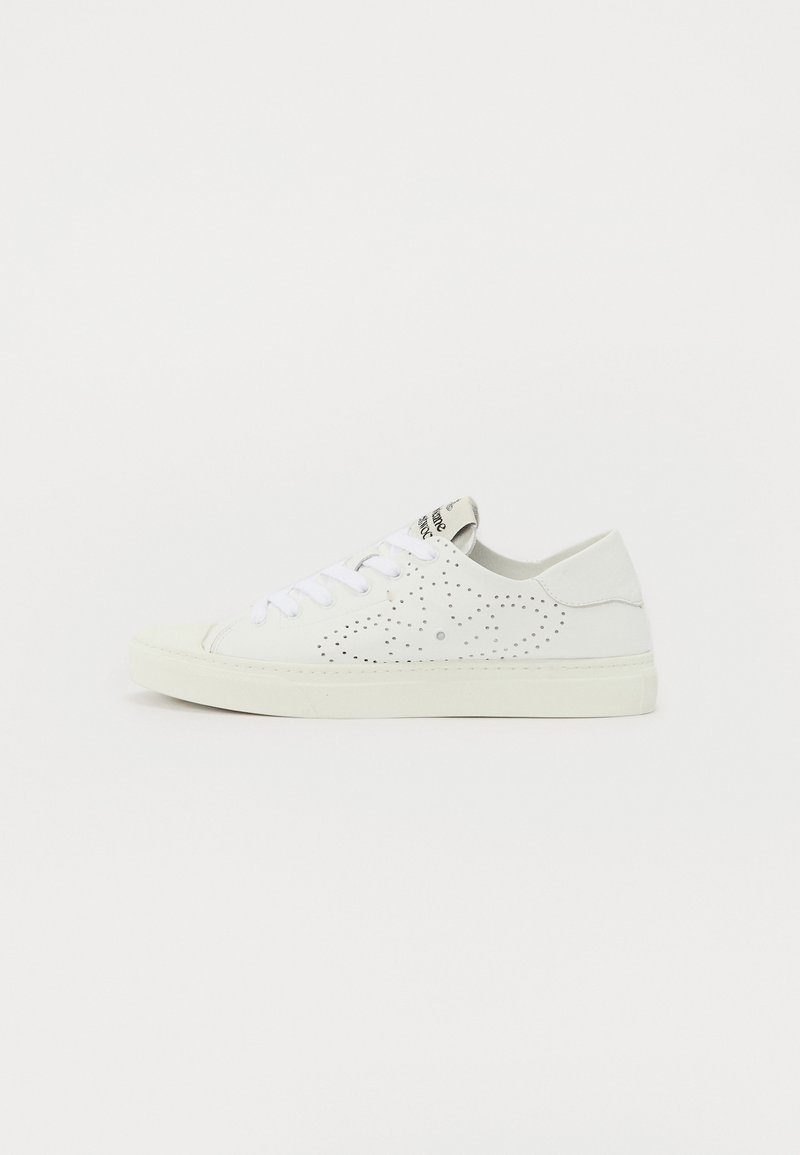 White sneakers with perforated design, flat rubber sole, and white laces. Rounded toe and subtle branding on the tongue. Smooth texture.