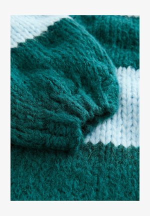 Teal knitted sweater featuring a ribbed cuff and a contrasting white stripe pattern. Soft texture with loose, fluffy yarn details.