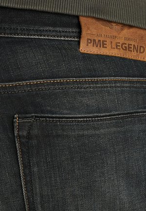 Denim jeans in dark blue with a textured finish. Features orange stitching and a brown leather tag labeled "PME Legend" on the waistband.