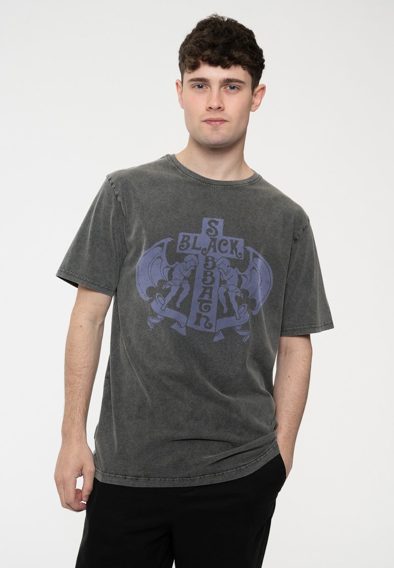 Gray cotton t-shirt featuring a faded graphic design of a cross and figures in purple. Short sleeves and a relaxed fit with a round neckline.