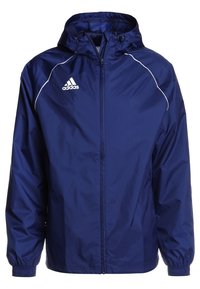 Veste coupe-vent bleu marine avec une fermeture éclair à l'avant et une capuche ajustable. Présente des accents blancs et le logo Adidas sur la poitrine gauche.