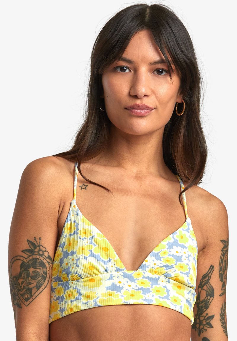 Bralette floreale realizzato in tessuto a coste giallo, blu e bianco. Presenta una scollatura a V profonda e spalline sottili regolabili.