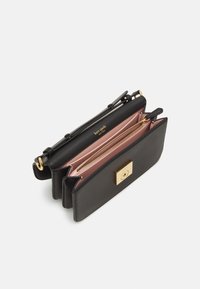 Black leather handbag with a rectangular shape, dual compartments, gold-tone hardware, and a front clasp. Interior features a pink lining.