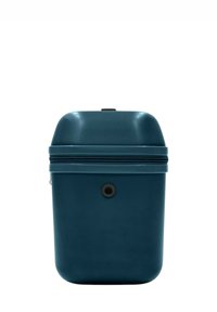 Custodia da viaggio rigida di colore verde acqua con superficie testurizzata, parte superiore arrotondata, chiusura con zip e un dettaglio centrale di pulsante nero sul fronte.