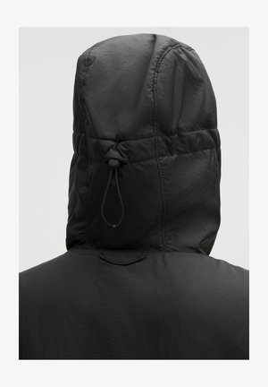 Black hooded jacket featuring a textured, lightweight material. The hood has an adjustable toggle and gathers at the neckline.