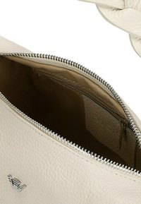 Borsa in ecopelle color crema con una cerniera argentata, caratterizzata da un'esterno testurizzato e un interno liscio. Include una piccola tasca con cerniera all'interno.