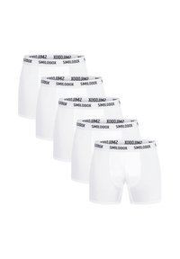 Vita boxer shorts med svart "SMILODOX" midjeband, som har en bekväm passform och mjukt tyg. Fem par ligger radade i en rad.