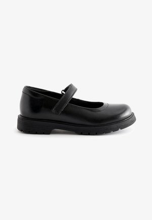 Chaussure Mary Jane en cuir noir avec un bout rond et une sangle ajustable. Présente une semelle en caoutchouc noir texturé pour une meilleure adhérence et durabilité.