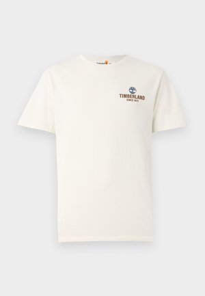 T-shirt in cotone, color crema, collo rotondo, maniche corte, con logo blu Timberland e testo "SINCE 1973" in marrone. Fit regolare.
