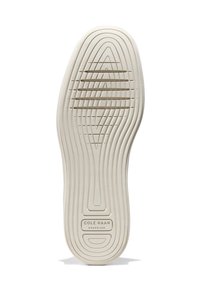 Suela de zapato de goma blanca con patrones texturizados, ranuras y un logotipo que dice "COLE HAAN GRAND.36." Acabado suave y diseño flexible.