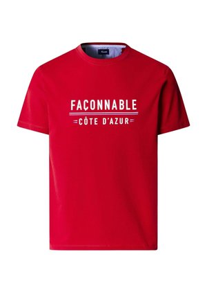 T-shirt rouge à manches courtes avec le texte blanc "FAÇONNABLE" et "CÔTE D'AZUR" imprimé sur le devant.