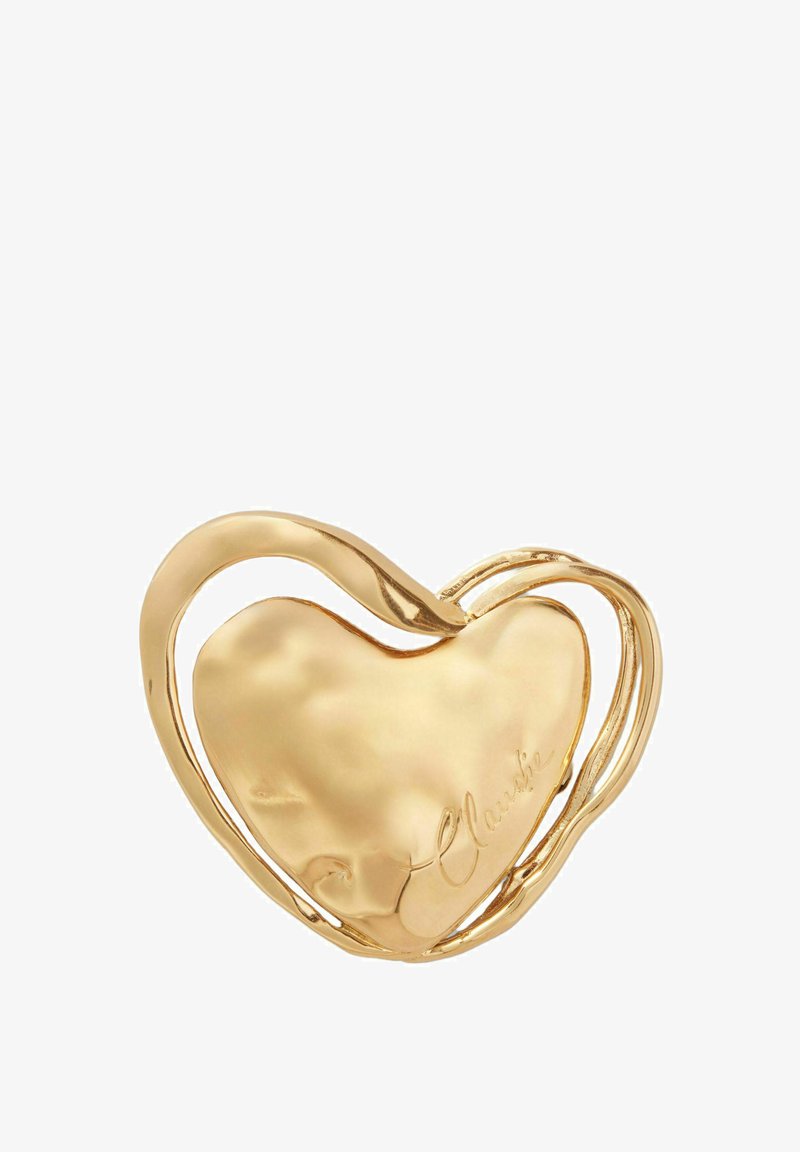 Pendentif en or en forme de cœur avec une surface lisse et des accents entrelacés. Présente le texte gravé "Claudie" d'un côté.