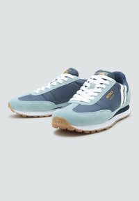 Pair of blue and teal athletic sneakers with white laces, gum soles, and "Patrick Monza" branding on the side, displayed on gray background.