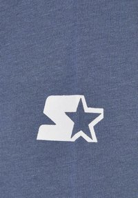 Blue fabric with a textured knit; features a prominent white graphic logo consisting of an "S" shape with a star. Simple and modern design.