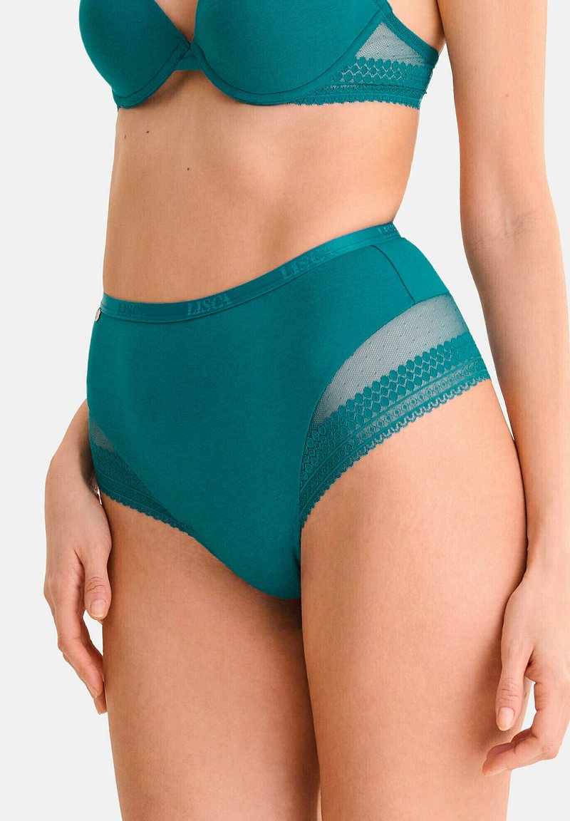 Culotte taille haute turquoise en tissu lisse, avec des accents en dentelle sur les côtés et une bande logo à la taille. Coupée dans un style classique.