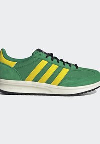 Green sneaker with yellow stripes, black laces, and white sole labeled Cloudfoam, shown from the side on a plain background.