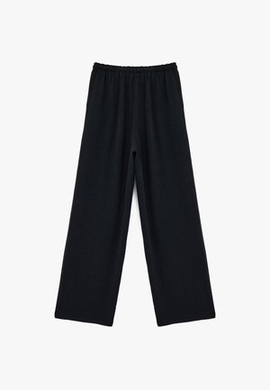Zwarte wijdvallende broek van zacht, textuurstof met een elastische tailleband voor comfort. Geen zichtbare patronen of hardwaredetails.