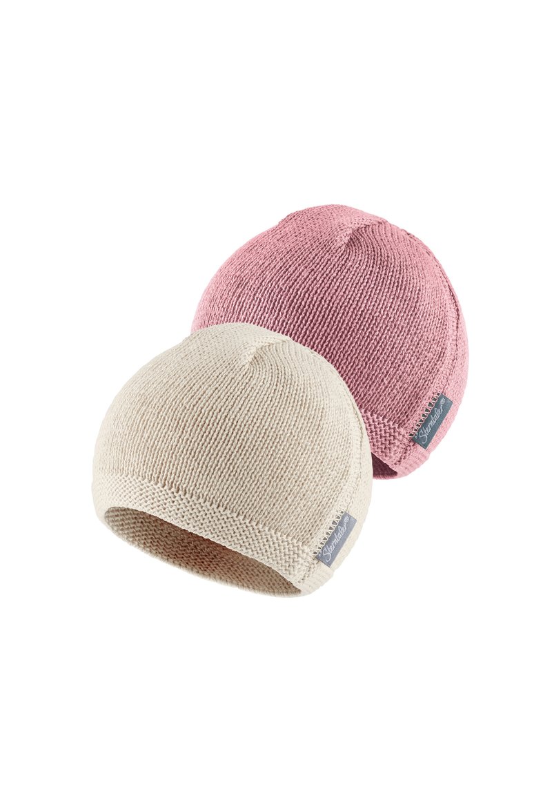 Two knit beanies, one beige and one light pink. Both have a rounded top and a small logo patch on the side, with textured fabric.