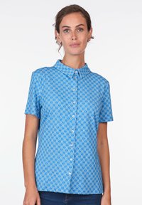 Blaues Kurzarmhemd mit Wellenmuster, Knopffront und Kragen. Hergestellt aus leichtem Stoff mit glatter Textur.