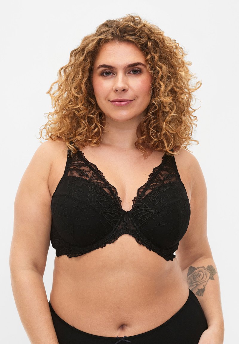 Black lace bra featuring floral embroidery, a structured shape, and scalloped edges. Adjustable straps enhance fit and comfort.