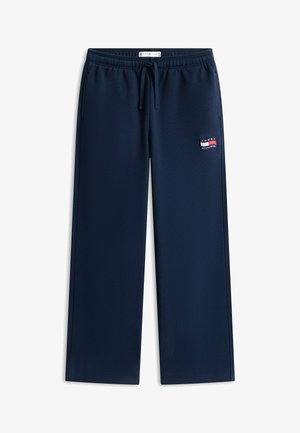 Pantalon de survêtement bleu marine à jambes droites avec ceinture élastique, cordon de serrage, poches latérales et logo Tommy Hilfiger sur la cuisse gauche.
