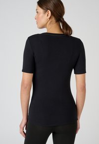 Black short-sleeve t-shirt with a fitted design, smooth texture, and a rounded neckline. Features subtle stitching detail at the neck.