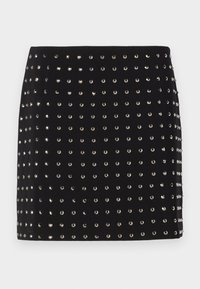 Svart mini skjørt med en tettsittende design, som har et mønster av sølvpaljetter jevnt fordelt over stoffflaten.