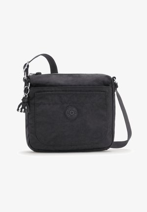 Black crossbody bag with a smooth texture, featuring a front pocket, logo badge, detachable charm, and an adjustable strap.