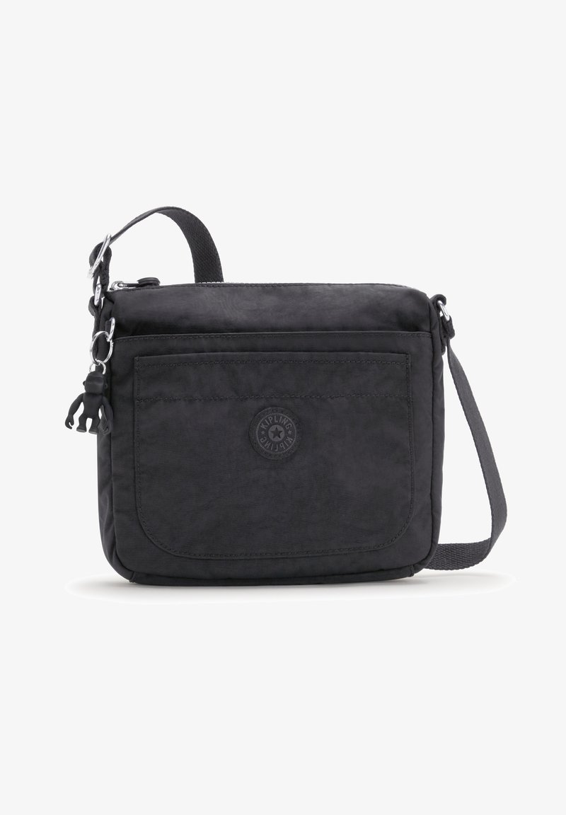 Black crossbody bag with a smooth texture, featuring a front pocket, logo badge, detachable charm, and an adjustable strap.