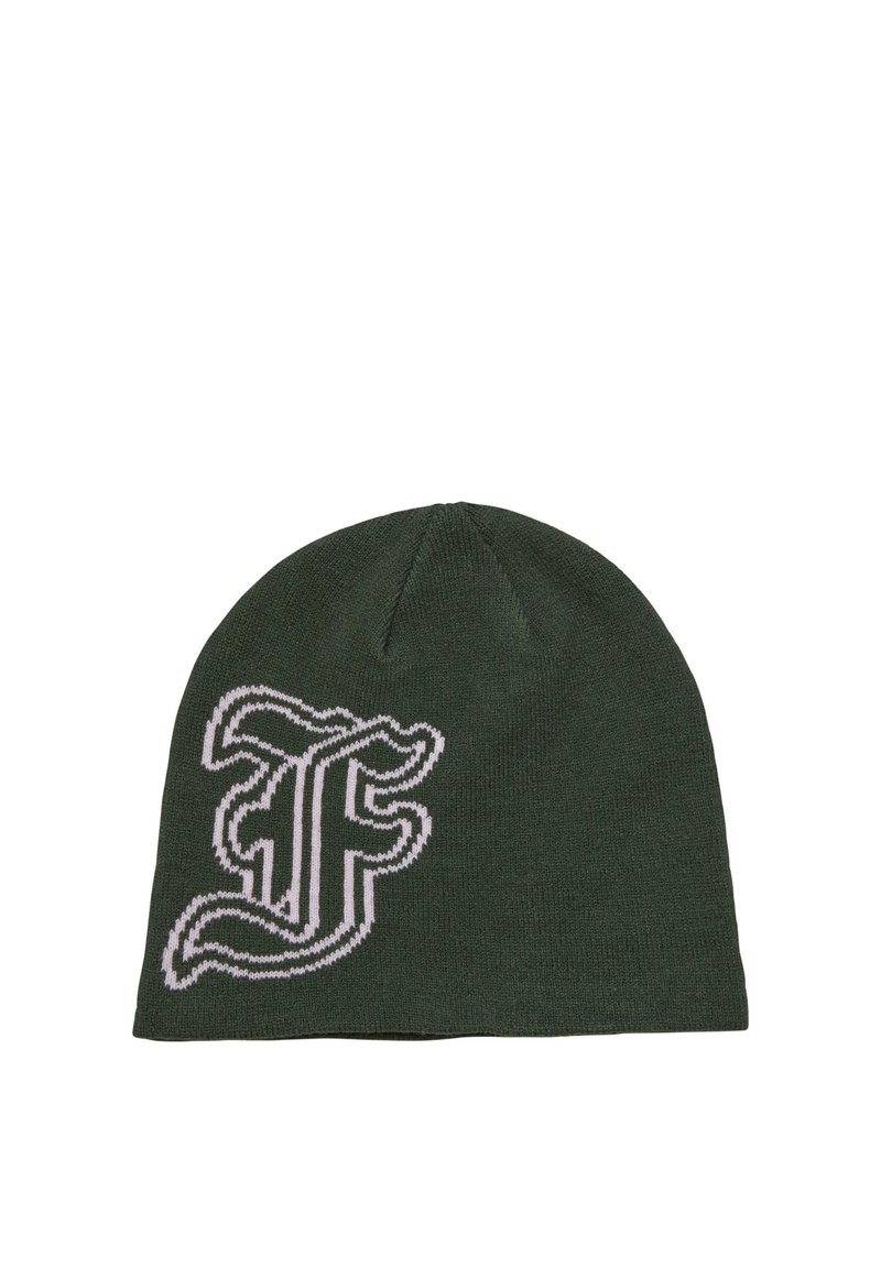 Green knit beanie featuring a prominent white and black woven logo. Soft texture with a classic, rounded shape and ribbed edge.