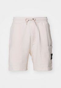 Light beige cotton shorts with an elastic waistband, drawstring, side pockets, and a notable black patch label on the side.