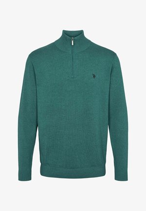 Tyrkysový pletený svetr s vysokým límcem a zipem na půl. Má žebrované manžety a spodní lem, s malým logem na hrudi.