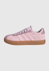 Light pink sneakers with suede upper, textured pink accents, three white stripes, and a gum rubber sole. Rounded toe design.