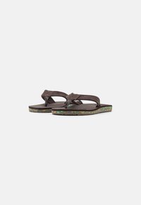 Brown flip-flop sandals with a soft textured strap and a colorful speckled sole. Flat design with a rubber base for comfortable wear.