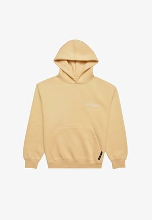 Beige kapuutsiga särke pehmest kangast, millel on esi-tasku, reguleeritav kapuuts ja valge trükk rinnal.