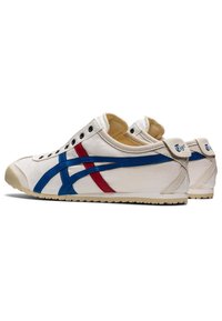 Sneaker bianche in tela con strisce blu e rosse, punta arrotondata, suola in gomma, occhielli in metallo e colletto imbottito. Logo del marchio sul tallone.
