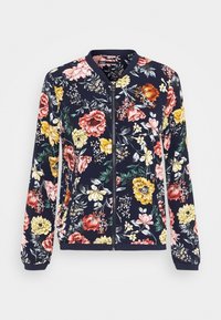 Veste bombardier florale en bleu marine, avec une fermeture éclair sur le devant, des manches longues, et un mélange de fleurs colorées en rose, jaune et rouge.