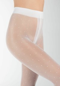Collant bianchi trasparenti con motivo a pois, texture liscia e ampia vita elasticizzata. Il design sottolinea leggerezza e trasparenza.