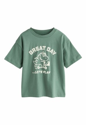 Green cotton t-shirt with a crew neck, short sleeves, featuring white graphic text "GREAT DAY" and a cartoon dinosaur riding a scooter.